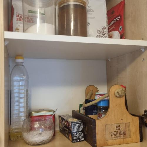 a pantry shelf with food and other items on it at Juuli apartament in Kuressaare