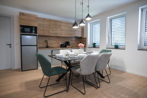 a kitchen with a dining room table and chairs at Apartma Ana in Krško