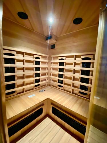 a sauna with wooden walls and windows at Appartement avec Sauna et Grand Spa in Béziers