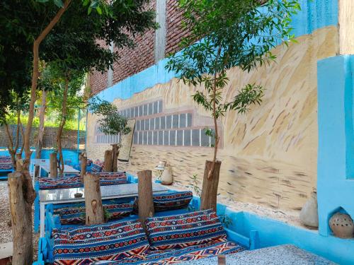 a group of benches with trees in front of a building at Pharaohs Rest Luxor in Luxor