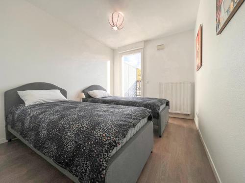 een slaapkamer met twee bedden en een raam bij Cenon plein ciel in Cenon