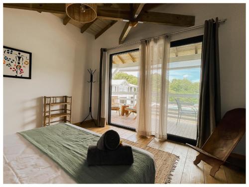 Postel nebo postele na pokoji v ubytování Les pilotis