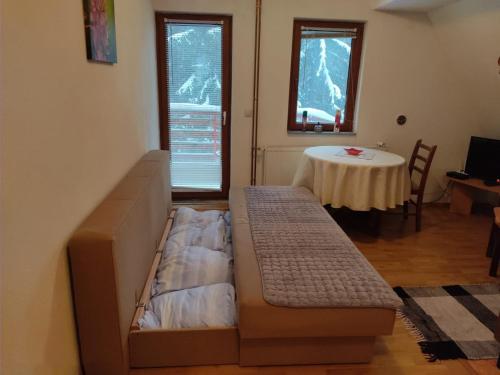 a living room with a couch and a table at Vikend kuća Libertas in Šišava
