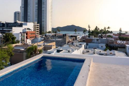 a swimming pool on the roof of a building at Cozy apartment just two blocks from the beach in Isla Venados
