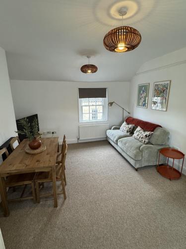 a living room with a couch and a table at Kingsmead Square Apartments in Bath
