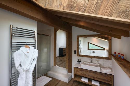 a bathroom with a sink and a mirror at ULTIMATE Les Gets Luxury - Above the Clouds with Sauna, Pool etc - Mansion Ensolielle for 15 in Les Gets