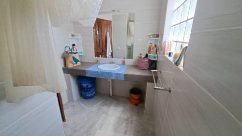 a bathroom with a sink and a mirror at Case sauvage in Diana