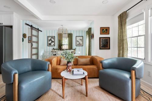 a living room with two chairs and a couch at Bright and Stylish Historic Grant Park Retreat in Atlanta