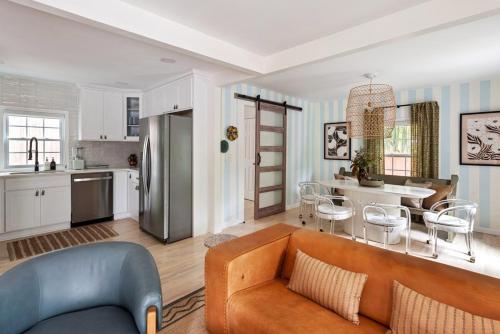 a living room with a couch and a kitchen at Bright and Stylish Historic Grant Park Retreat in Atlanta