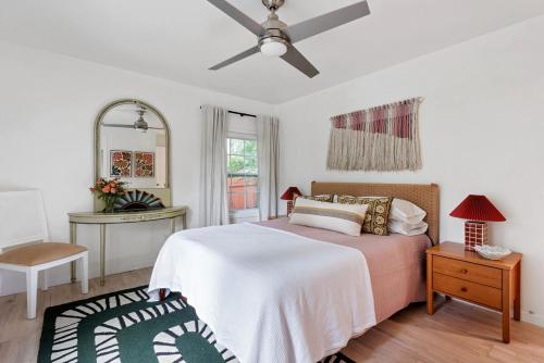 a bedroom with a bed and a ceiling fan at Bright and Stylish Historic Grant Park Retreat in Atlanta