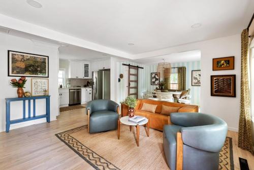 a living room with a couch and chairs and a table at Bright and Stylish Historic Grant Park Retreat in Atlanta