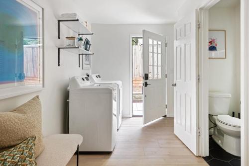 a white bathroom with a sink and a toilet at Bright and Stylish Historic Grant Park Retreat in Atlanta