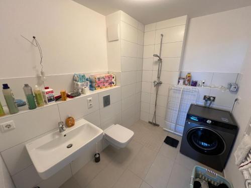 a bathroom with a sink and a washing machine at Premium Room near S-Bahn Station in Berlin