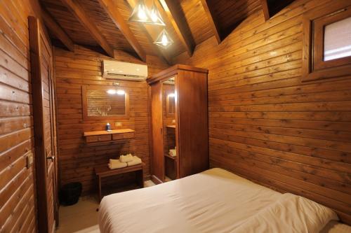 Un dormitorio con una cama en una habitación de madera. en La Cabana Beach Hotel Ain Sokhna, en Ain Sokhna
