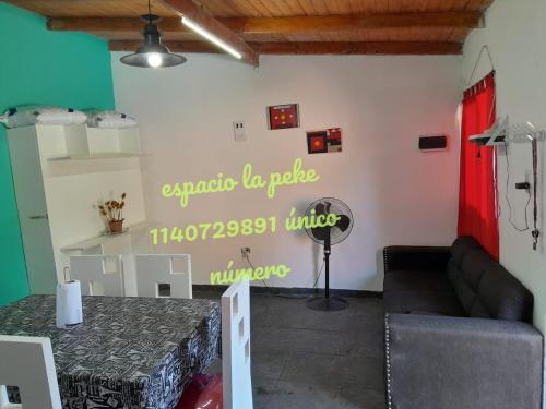 a living room with a table and a couch at quinta la peke in Ituzaingó