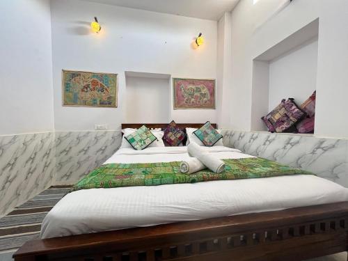 two beds in a room with white walls at Hotel haritage desert safari in Jaisalmer