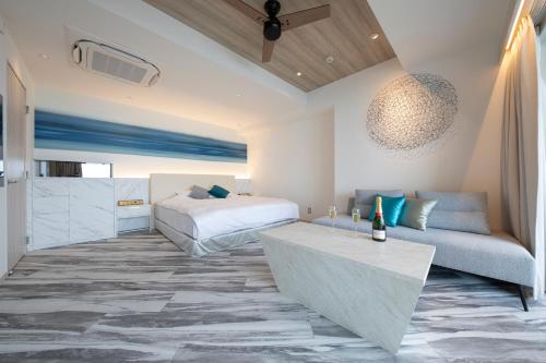 a bedroom with a bed and a couch at THE ZK West Coast in Awaji
