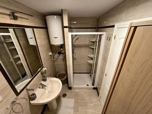 a small bathroom with a sink and a shower at A & G Sabinillas in San Luis de Sabinillas