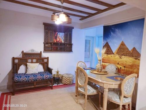 a dining room with a table and a bed at Lovely & Calm Rooftop in Maadi 5 min from the Nile in Cairo