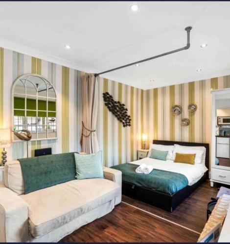 a living room with a bed and a couch at Between Piers, the stylish studio flat in Cannon place in Brighton & Hove