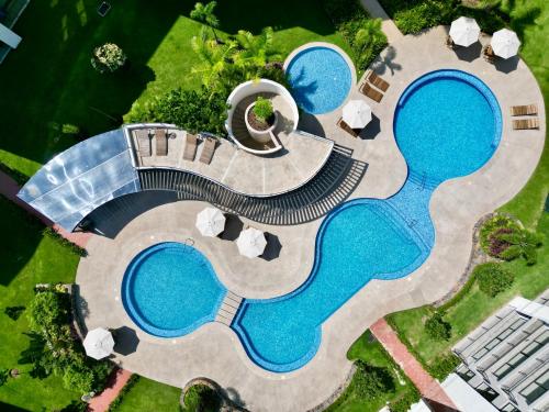 an overhead view of a pool with two swimming pools at Modern Luxury Residency at Altea-Sunset Pool View in Puerto Vallarta