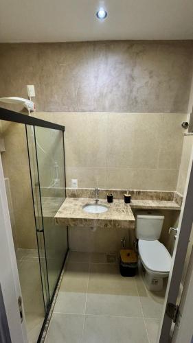a bathroom with a sink and a toilet at Loft Salvador in Salvador