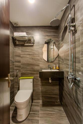 a bathroom with a toilet and a sink at Fusia Hotel & Apartment in Danang