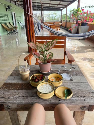 a table with bowls of food on top of it at The Atnal Lanta Budget and Eco Friendly hotel in Koh Lanta in Ko Lanta