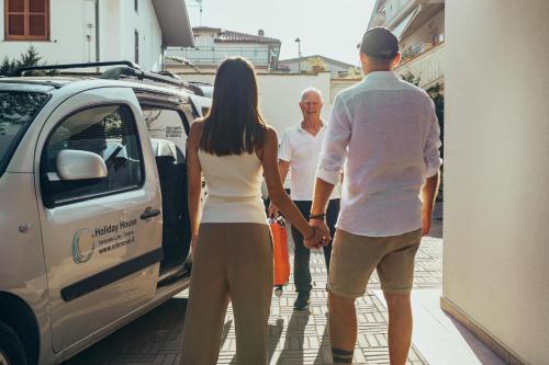 a man and a woman standing next to a van at Ellenove holiday house in Tortoreto Lido