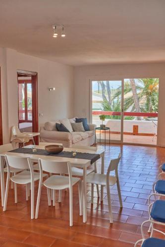 a living room with a table and chairs and a couch at Nura Houses Magaluf Apartment in Magaluf