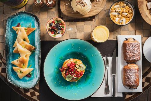 a table with plates of food on a table at Mare Hotel in Savona