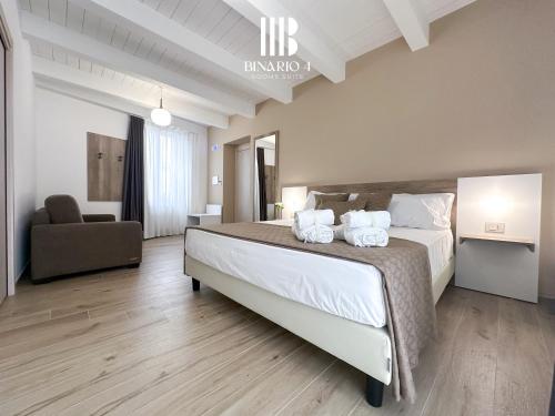 Ένα ή περισσότερα κρεβάτια σε δωμάτιο στο Binario 4 Rooms Suite