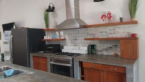 une cuisine avec une cuisinière et un réfrigérateur dans l'établissement Fishon Panama Lodge, à Boca Chica