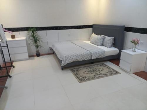 een slaapkamer met een bed en een tapijt bij إستراحة الريف in Kalbā