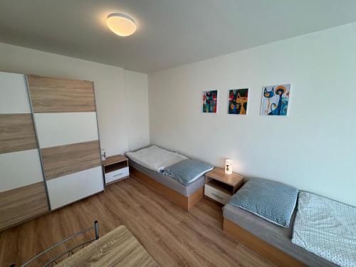 a small room with two beds and a cabinet at Apartmán Kocourkov in Jáchymov