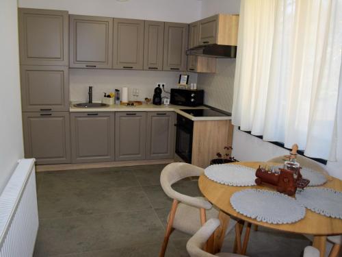 a kitchen with a wooden table and a table and chairs at Park home in Baia Mare
