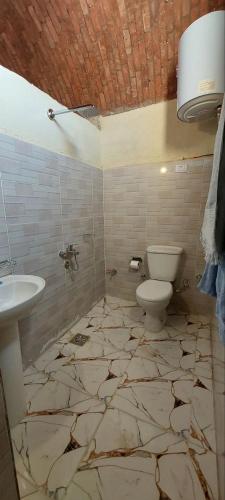 a bathroom with a sink and a toilet at Nile Domes Guest House in Luxor