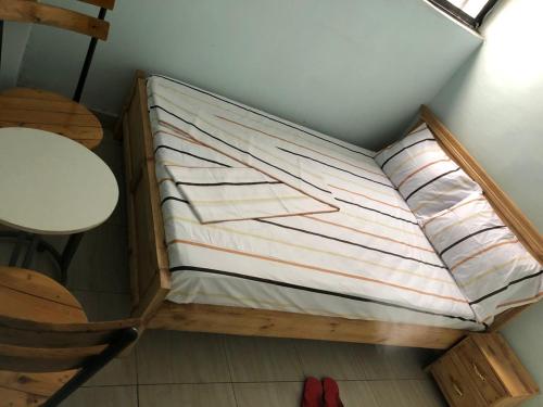 a small bed in the corner of a room at Blue Zone in Kigali