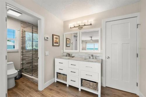 a bathroom with a sink and a toilet and a shower at A Tide that Binds Us By Beachside Management in Siesta Key