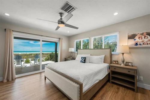 a bedroom with a bed and a large window at A Tide that Binds Us By Beachside Management in Siesta Key