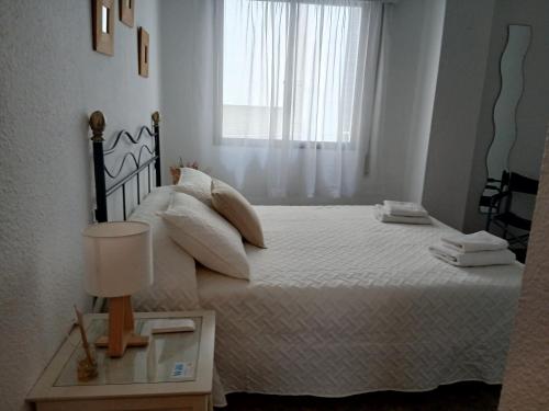 a bedroom with a large bed with a window at Apartamento Huelva Centro in Huelva