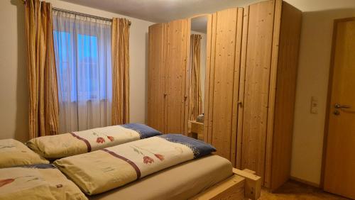 a room with two beds and a large window at Ferienhof Krug in Wiggensbach