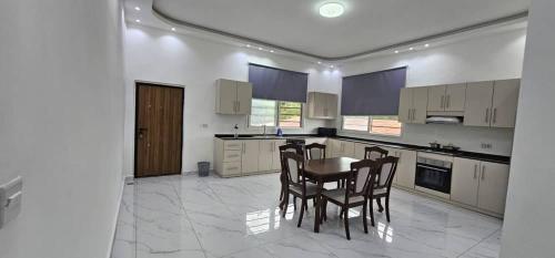 une cuisine avec une table et des chaises dans l'établissement Aberdeen SeaView Affordable Luxury Apartment by Richview, à Freetown