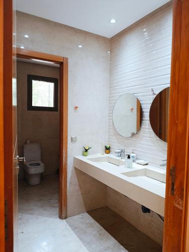 a bathroom with a sink and a toilet at Villa in Meknès