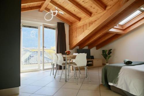 a bedroom with a bed and a table and chairs at La Fossola - vicino al Bernina Express in Tirano