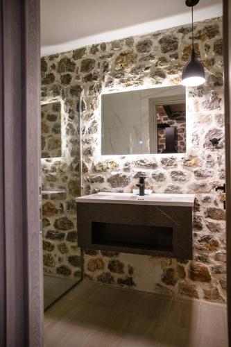 a bathroom with a sink and a mirror at Θριές Παρνασσός in Kalívia