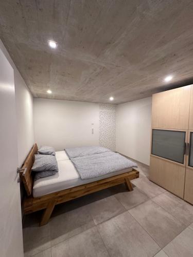 a bedroom with a bed and a flat screen tv at Innsbruck West in Inzing