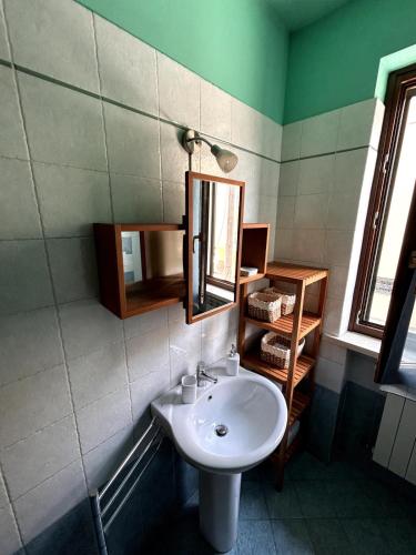 a bathroom with a sink and a mirror at Casa Similli in Lucca