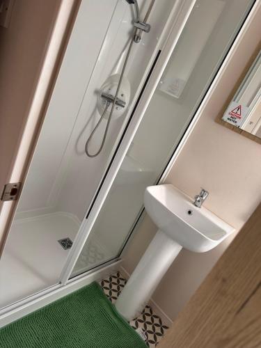 a bathroom with a shower and a sink at Cabin 100 in Warsash