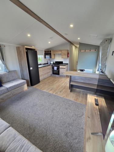 a large living room with a couch and a kitchen at 8 Berth Caravan Haven Marton Mere in Blackpool